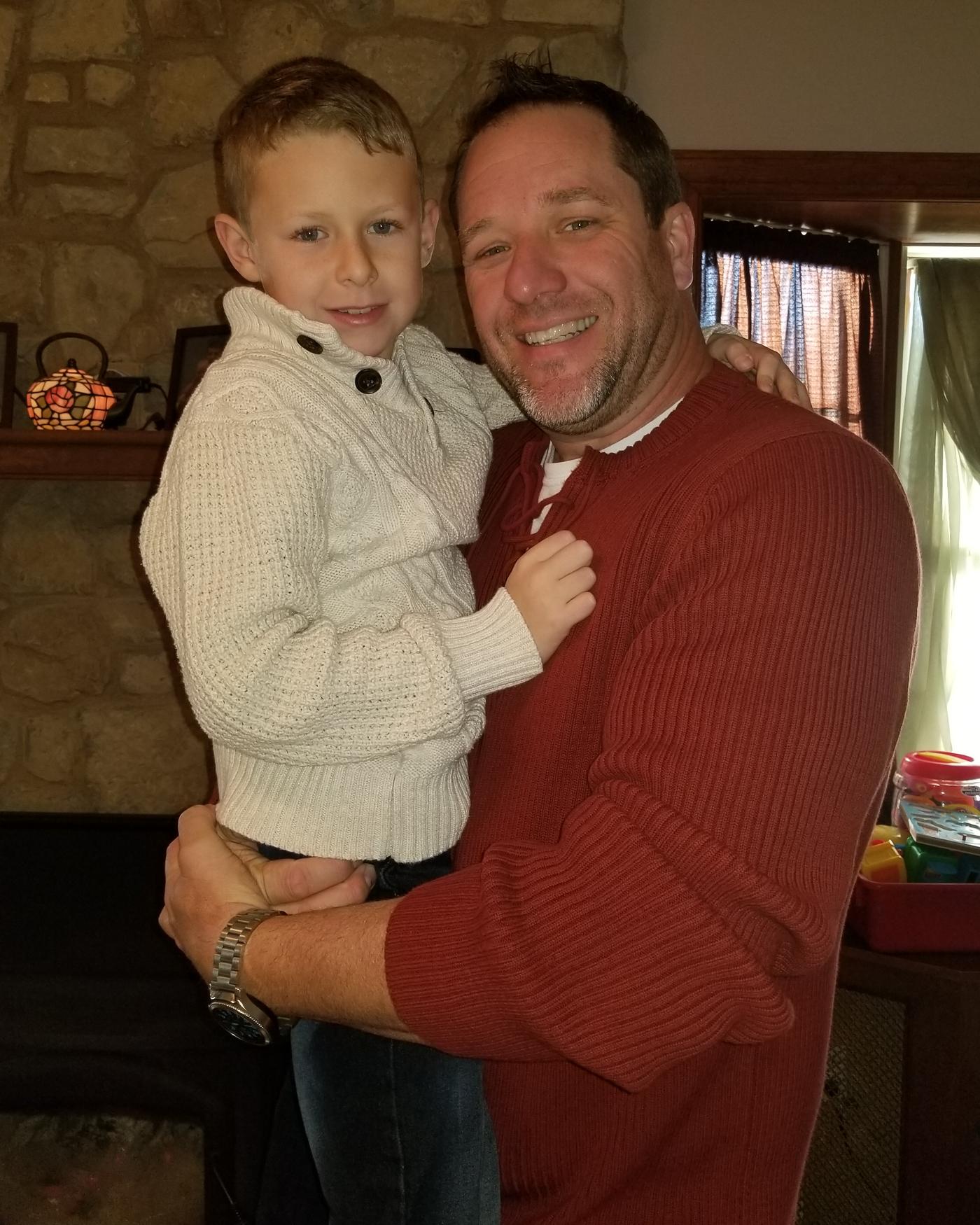 Andy Eberz holding his son at home